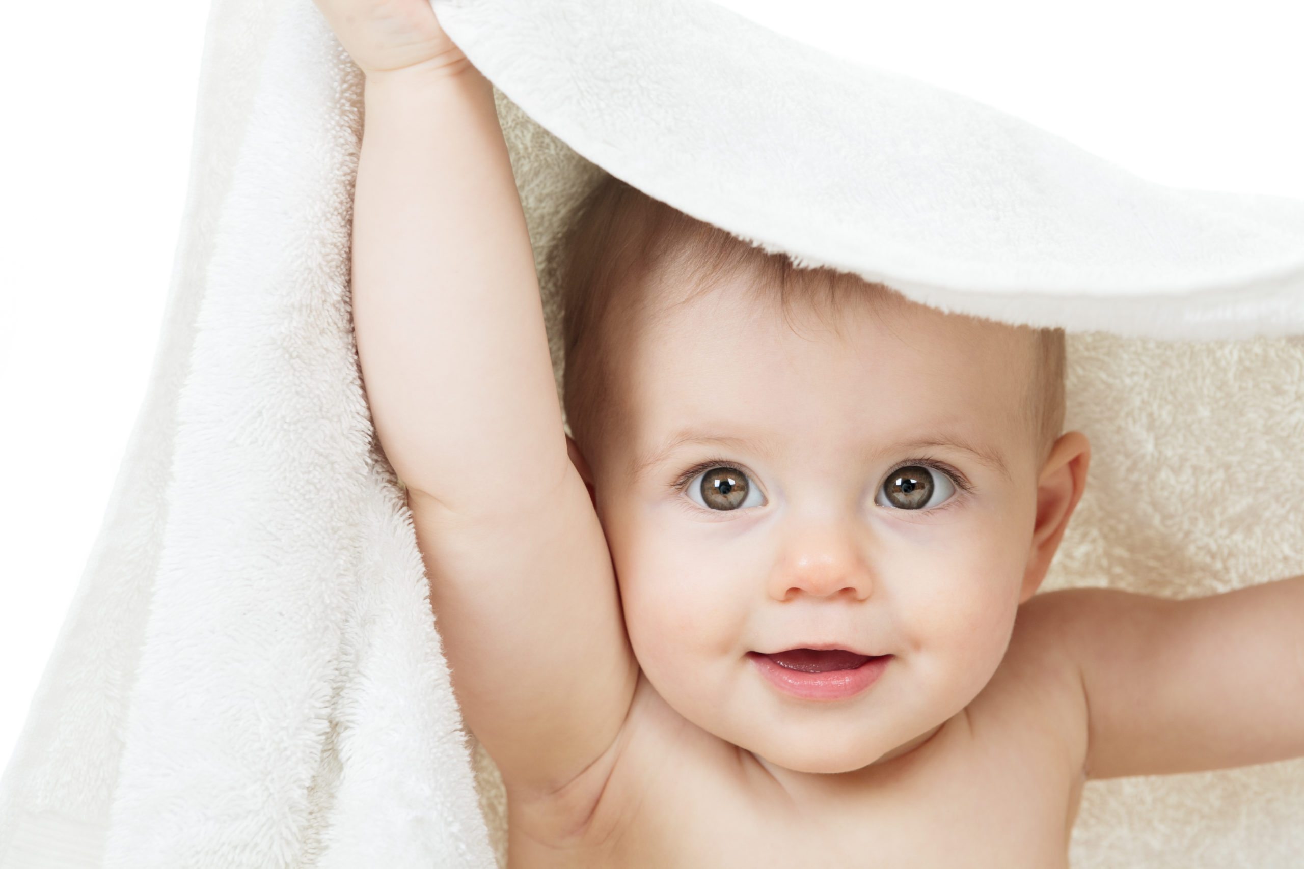 Nannies and mommies home page picture of baby holding up towel
